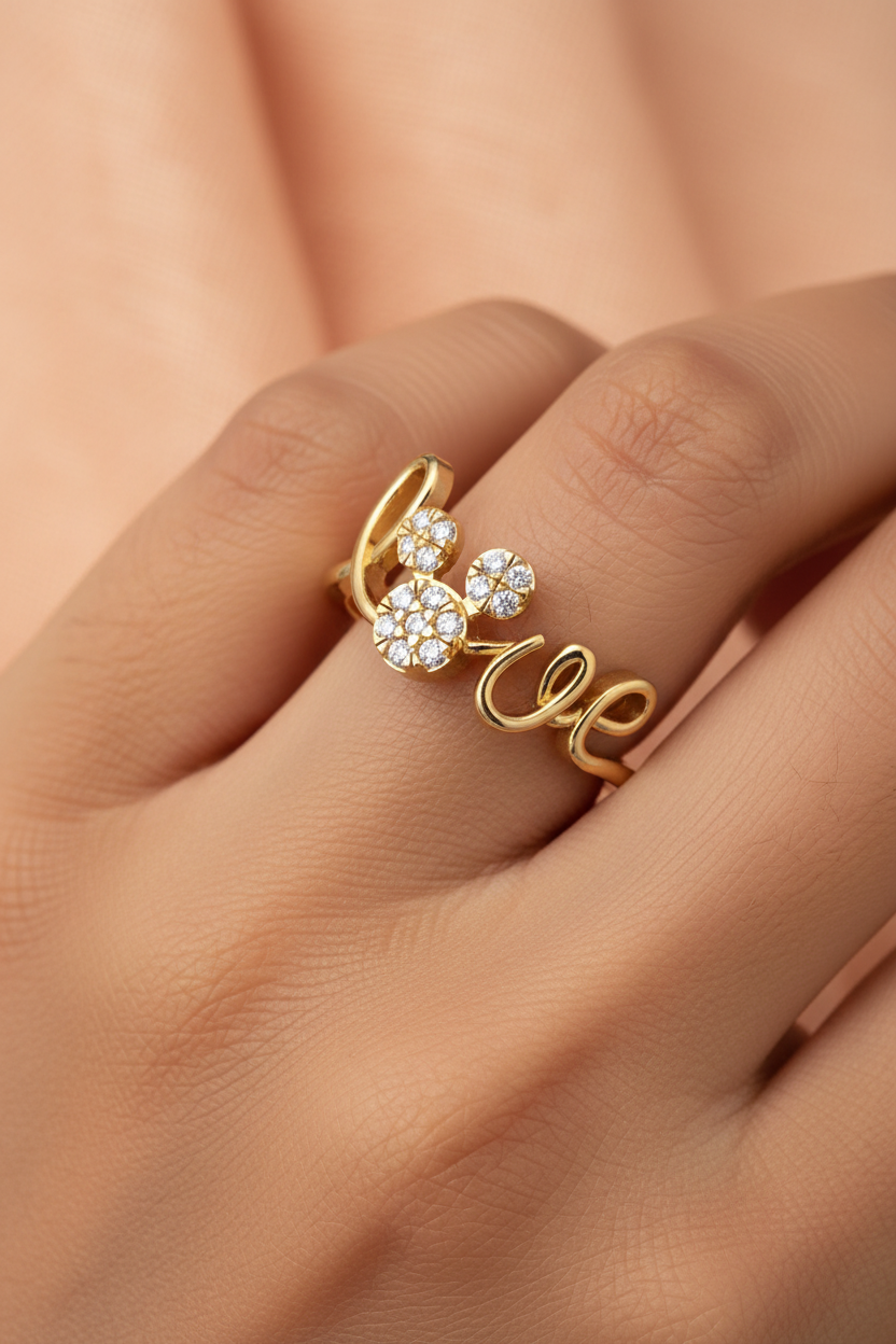Girl wearing yellow gold cursive love script diamond ring