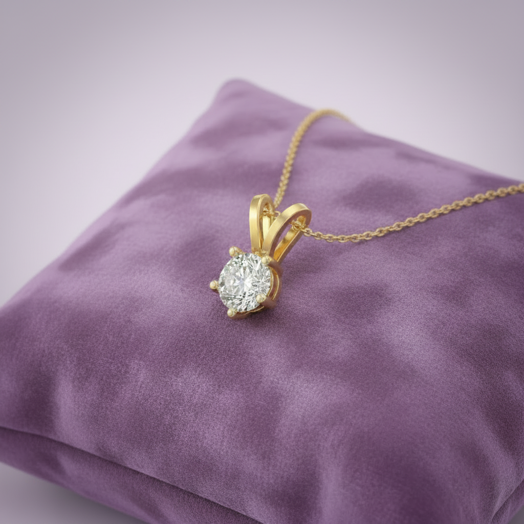Gold solitaire diamond pendant on lavender cushion