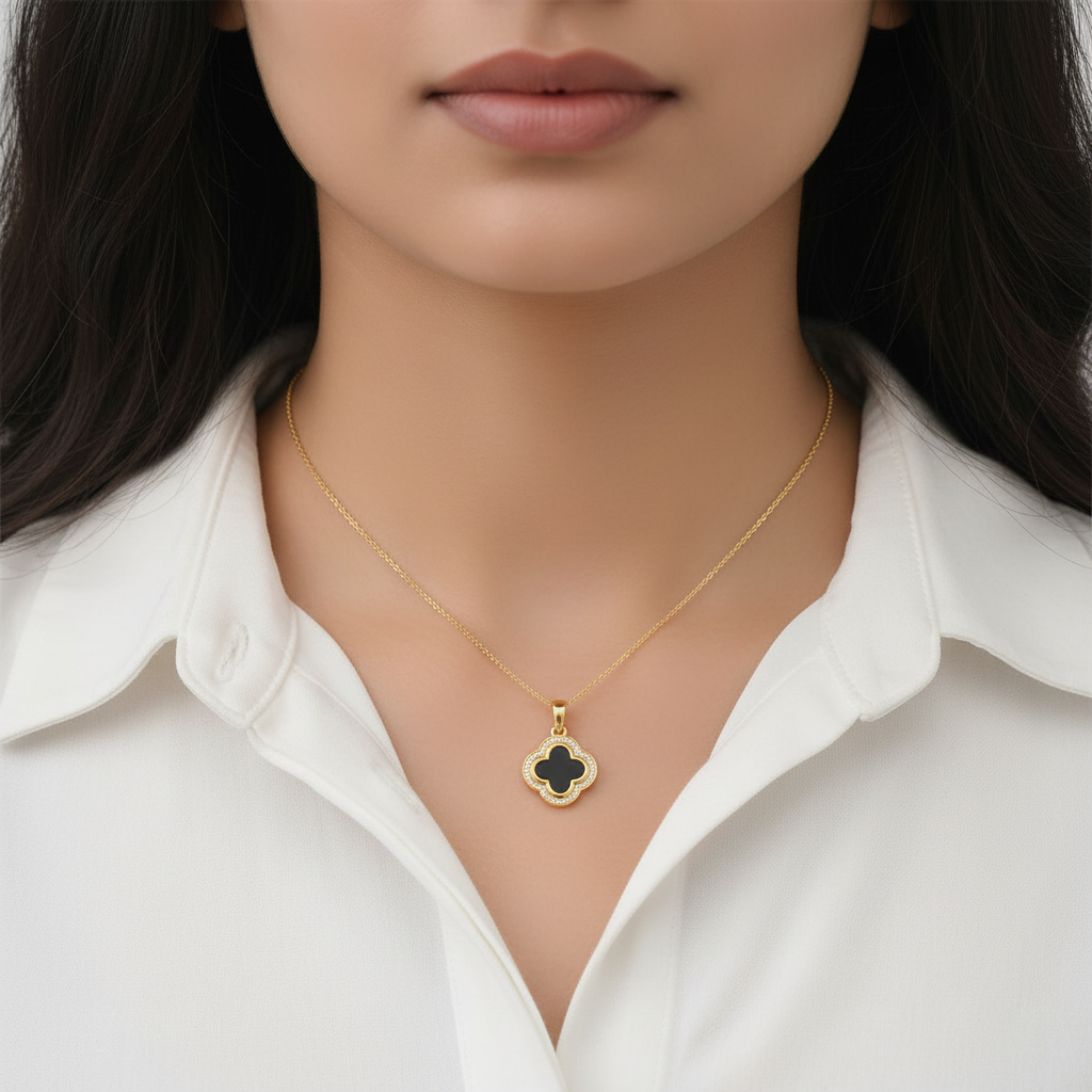 Indian woman neck close-up in white shirt wearing tiny yellow gold black onyx clover diamond pendant