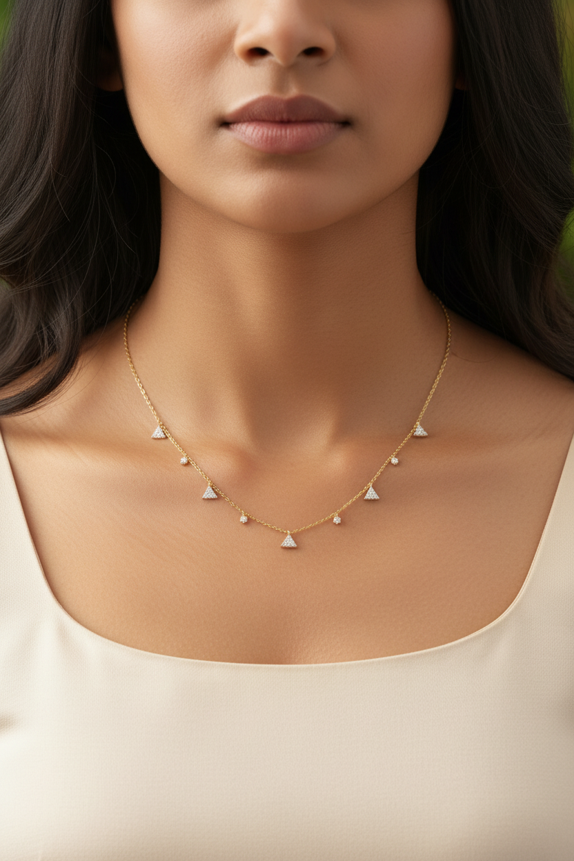 Indian woman neck close-up wearing correct yellow gold 5 triangle 4 diamond station necklace
